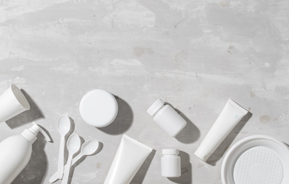 A flat lay of plastic beauty products waiting to be recycled