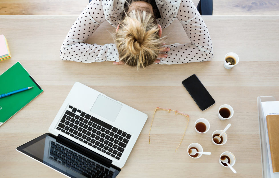 Young business woman napping at her desk to conquer Blue Monday
