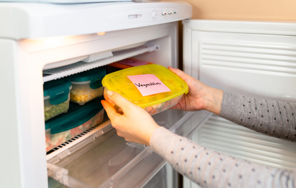 Woman labels her fruits and vegetables ready to be frozen during the coronavirus pandemic