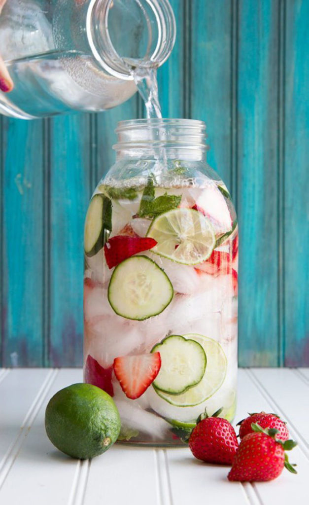 A jar of water, lime and strawvberries