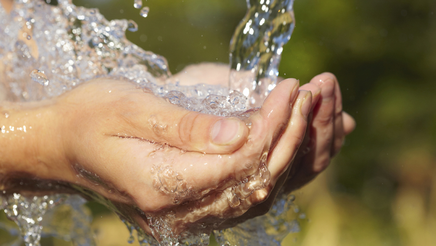 Woman's hands with water splash