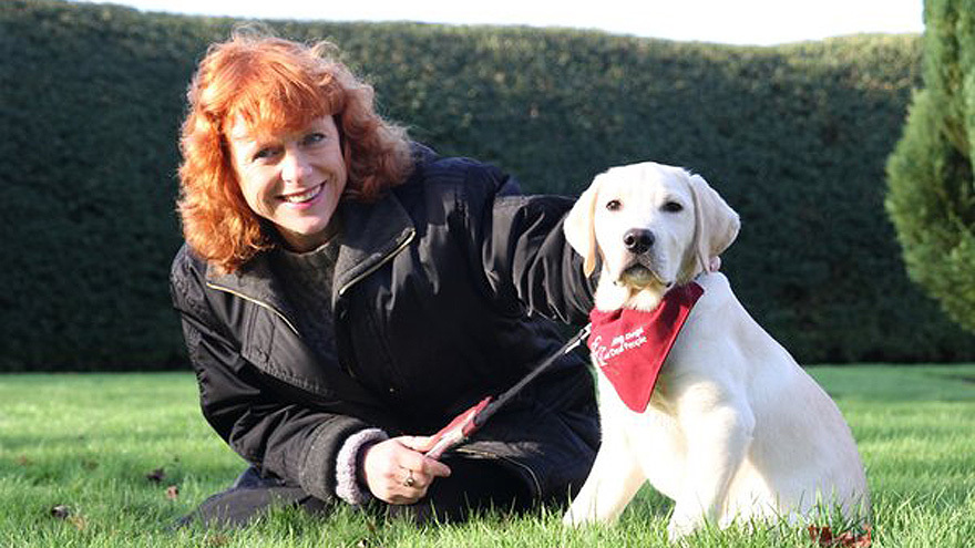 Dr Sarah Jarvis with a hearing puppy