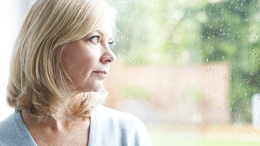 Sad Mature Woman Looking Out Of Window