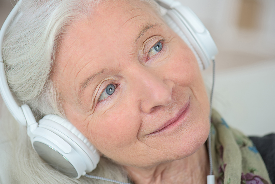 Lady listening to music before bed Pic: Rex/Shutterstock