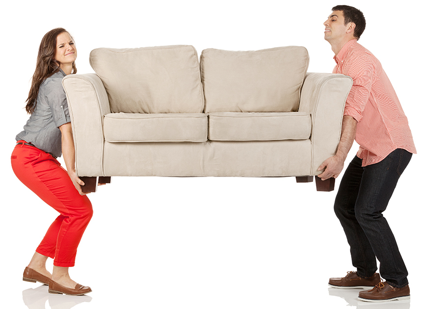 Young couple carrying sofa