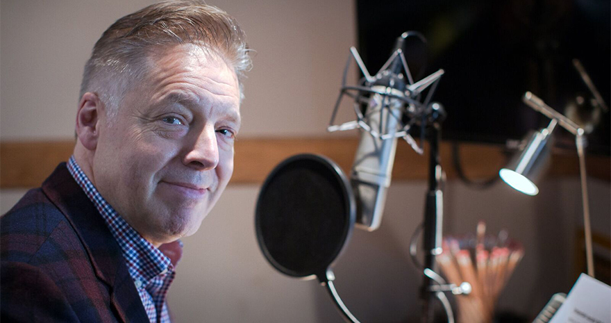 Stroke survivor DJ Mike Goodier at a radio microphone.