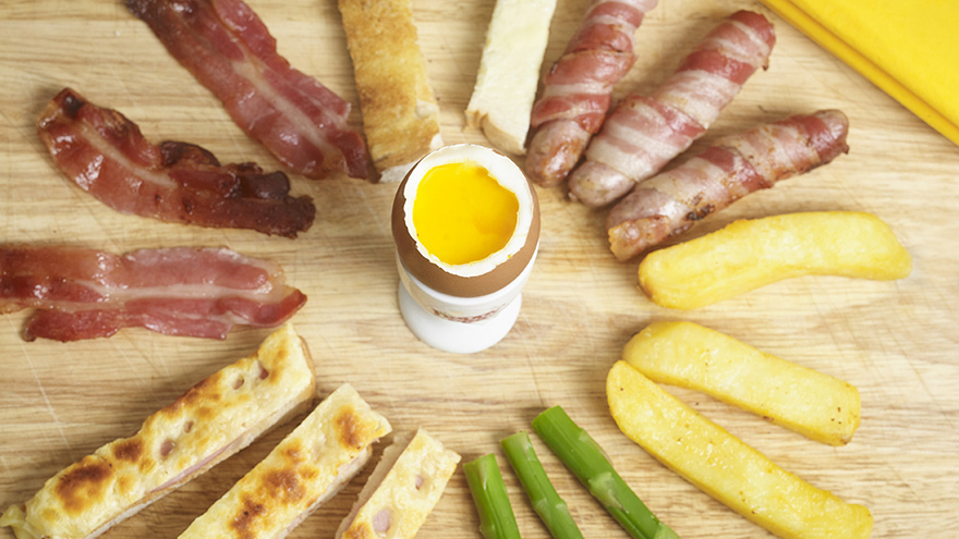 A boiled egg surrounded by dipping food