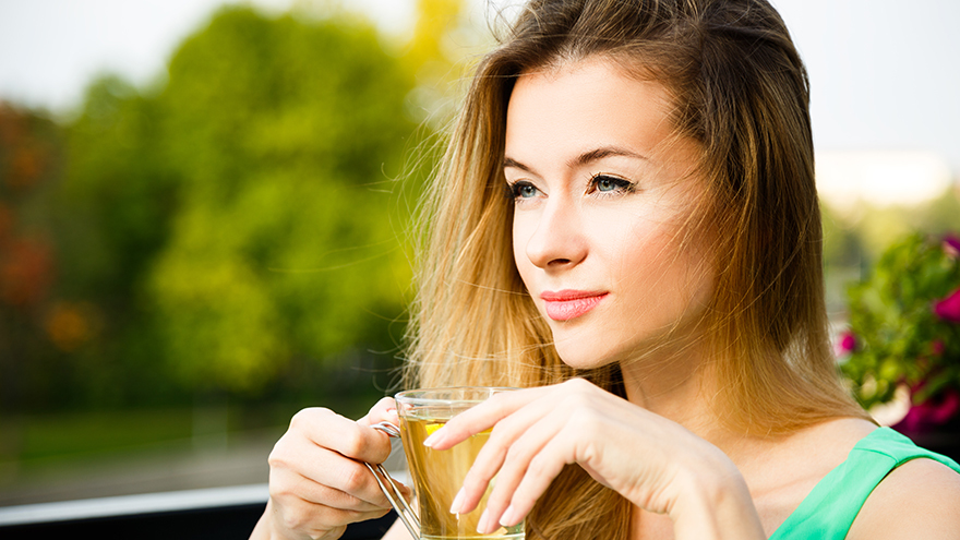 Young Woman Drinking Green Tea Outdoors