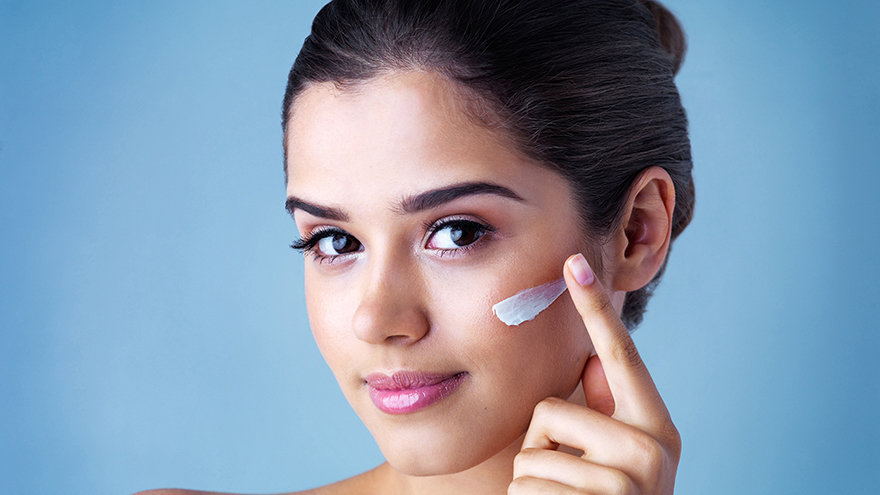 Studio portrait of a beautiful young woman applying face cream Pic: Istockphoto