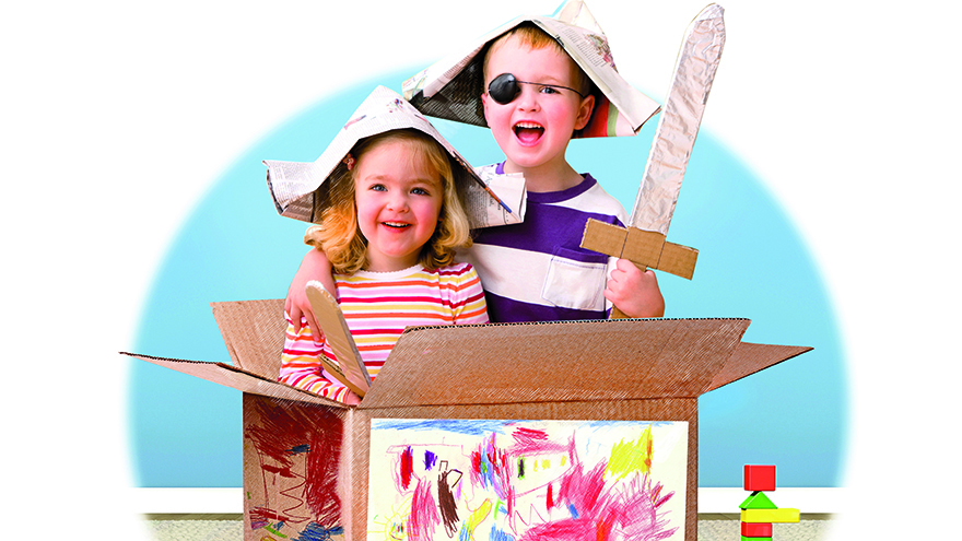 boy and girl playing in cardboard box