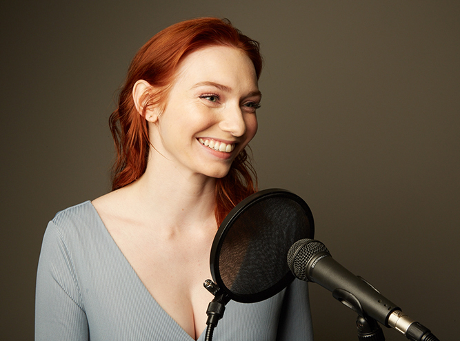Eleanor Tomlinson reads into a microphone