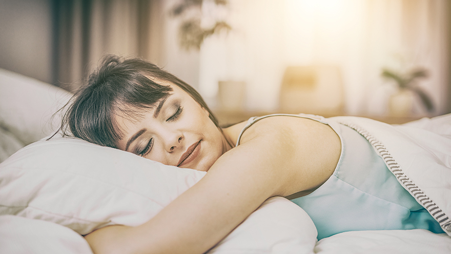 Beautiful young woman sleeping on a bed in the bedroom. A peaceful sleep makes you happy.