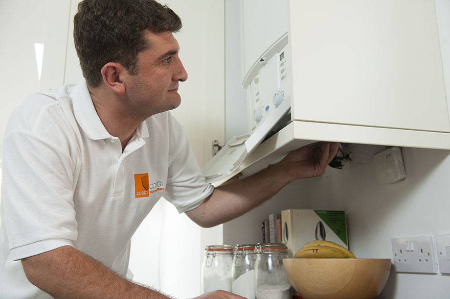 Gas engineer testing boiler