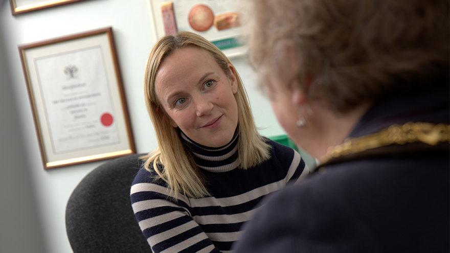 Optometrist Sarah Farrant talking to a patient