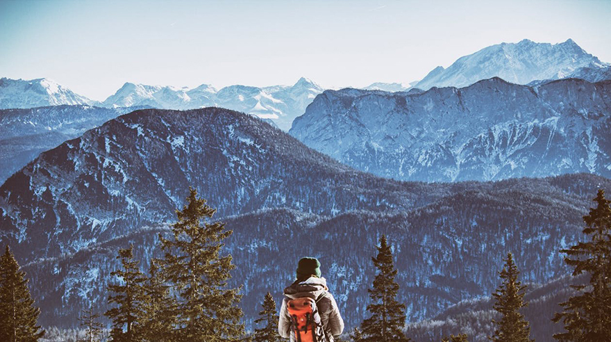 Sole backpacker looking at mountains