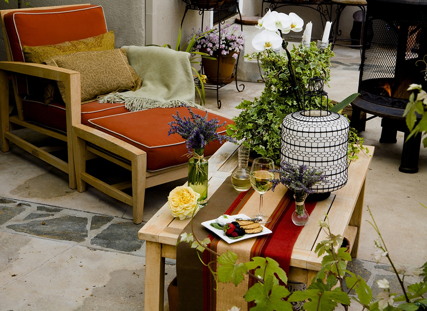 A patio with comfy chairs and table