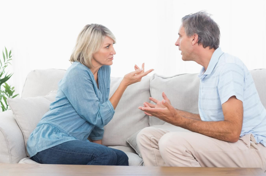 Couple arguing on settee