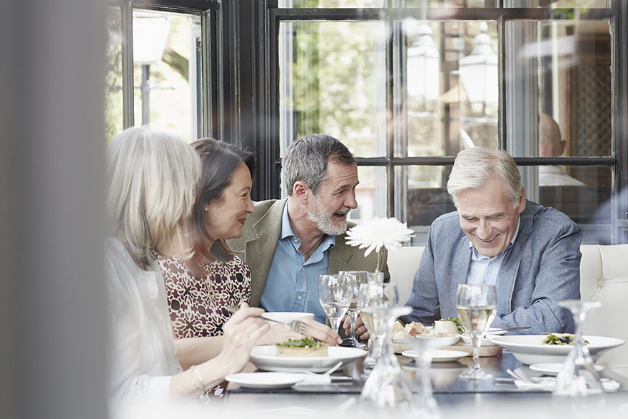 2 couples having a meal in a restaurant