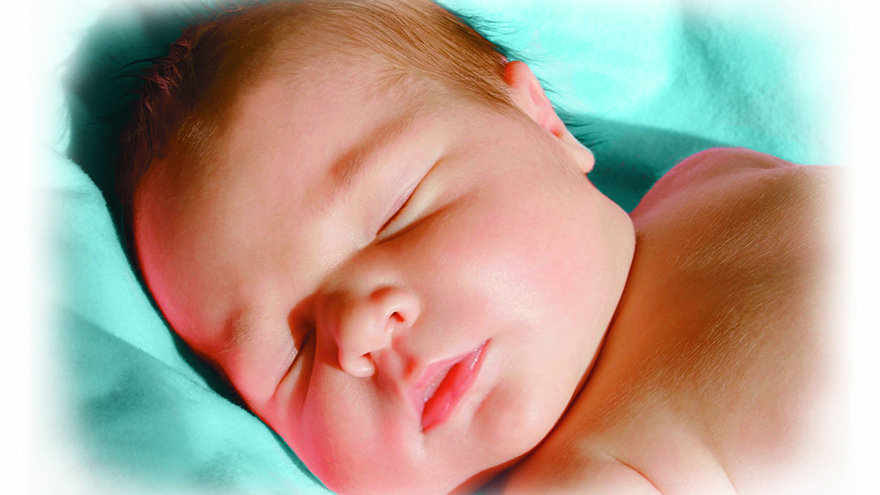 sleeping baby on blue cushion