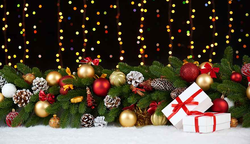 christmas decoration on white fur with fir tree branch closeup