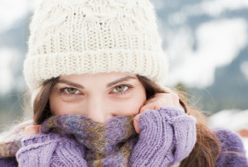 Woman in cap, scarf and gloves