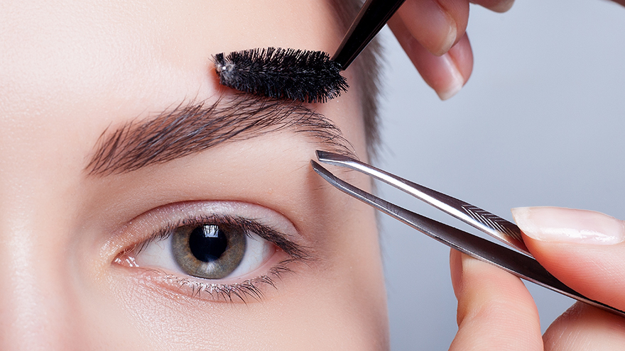 Lady tidying eyebrows Pic: Istockphoto