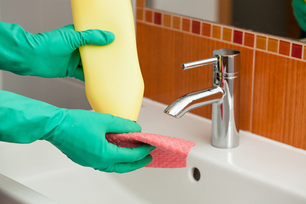 Pair of rubber gloves with Jif and a sponge