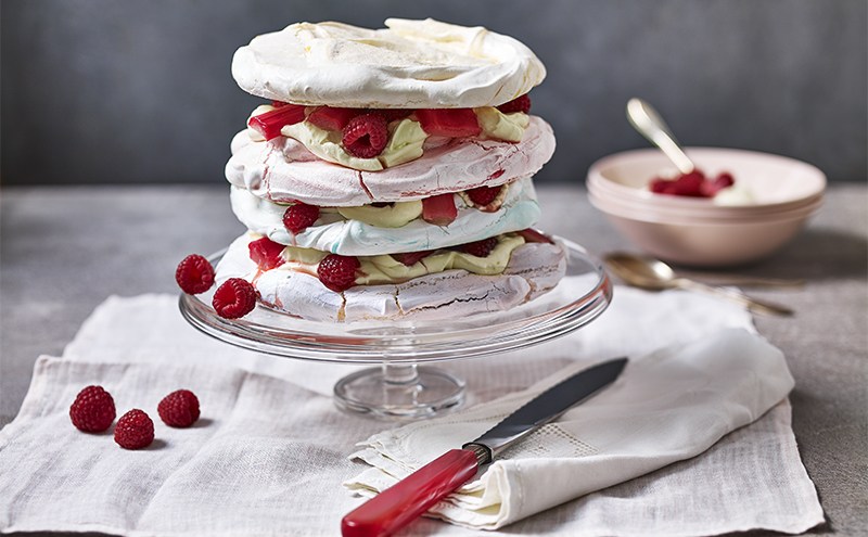 Layered dessert of large meringue discs and whipped cream mixed with fruit