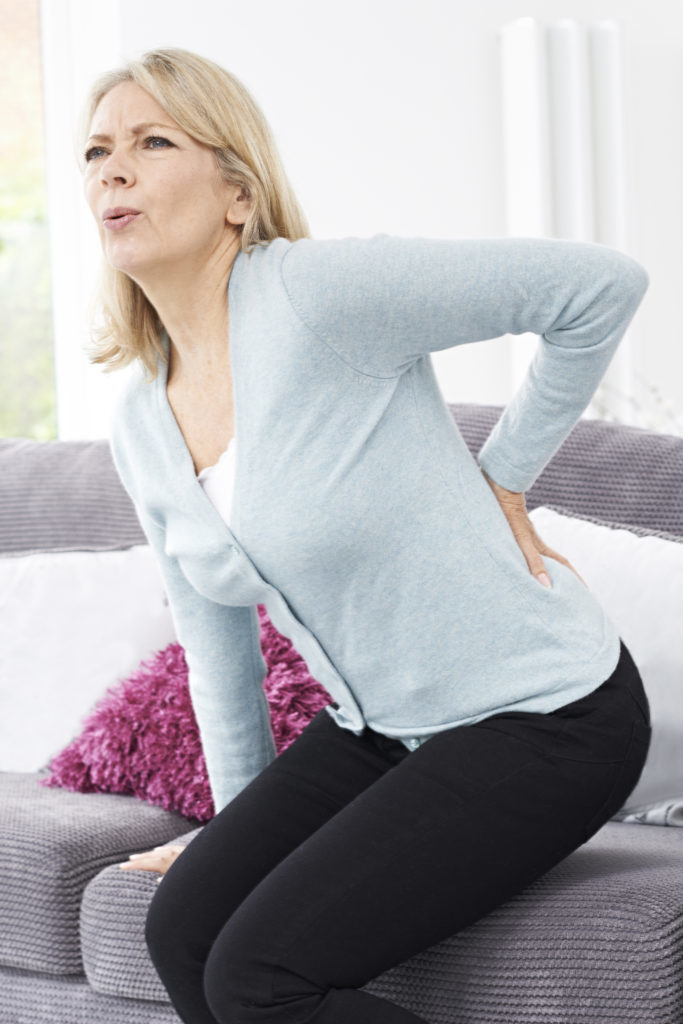 Mature Woman Suffering From Backache At Home