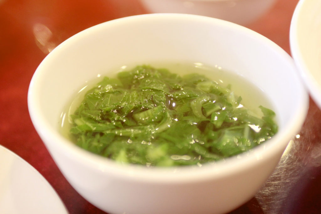 Green leaves clear vegetable soup, traditional vietnamese (asian) cuisine, focus