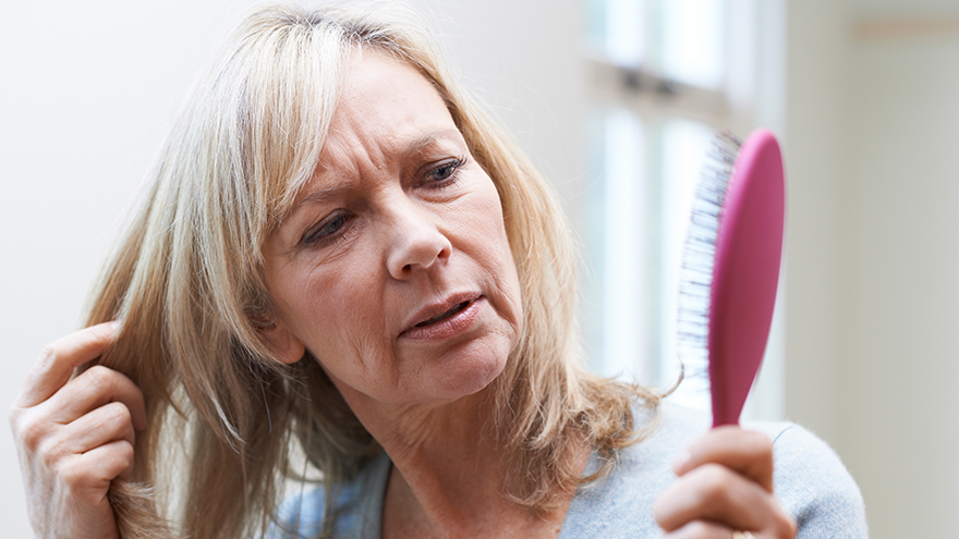 Blonde woman brushing her hair