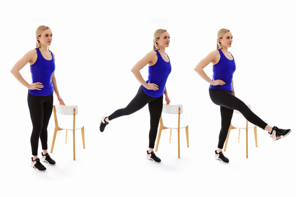 3 women doing leg rotations with chairs