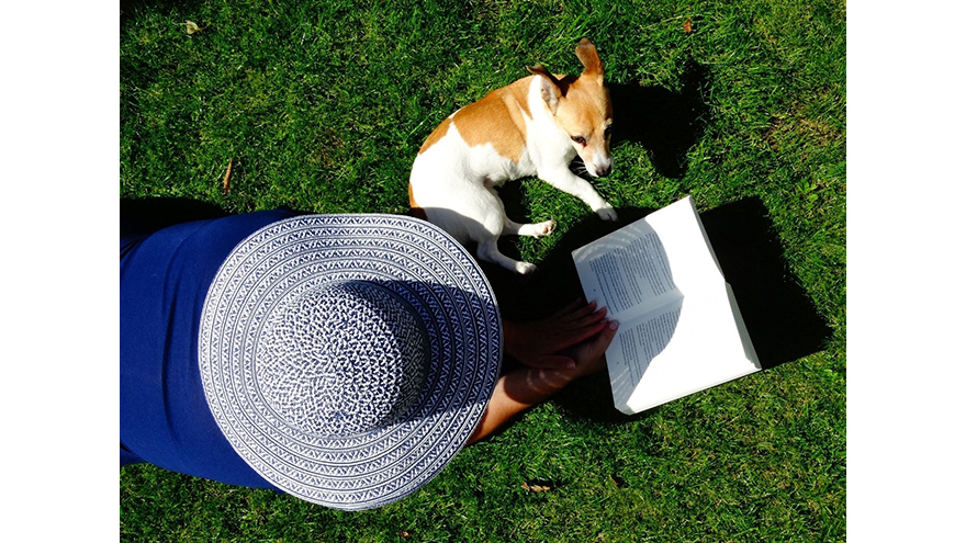 lady reading in garden with dog