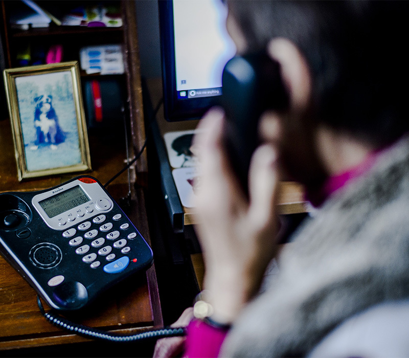 pet bereavement volunteer on the phone, back view