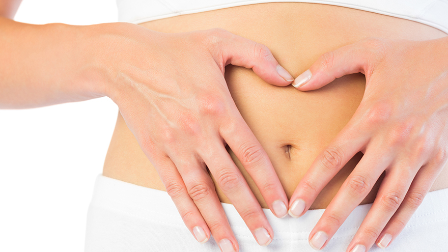 Close up picture of fit woman holding her belly