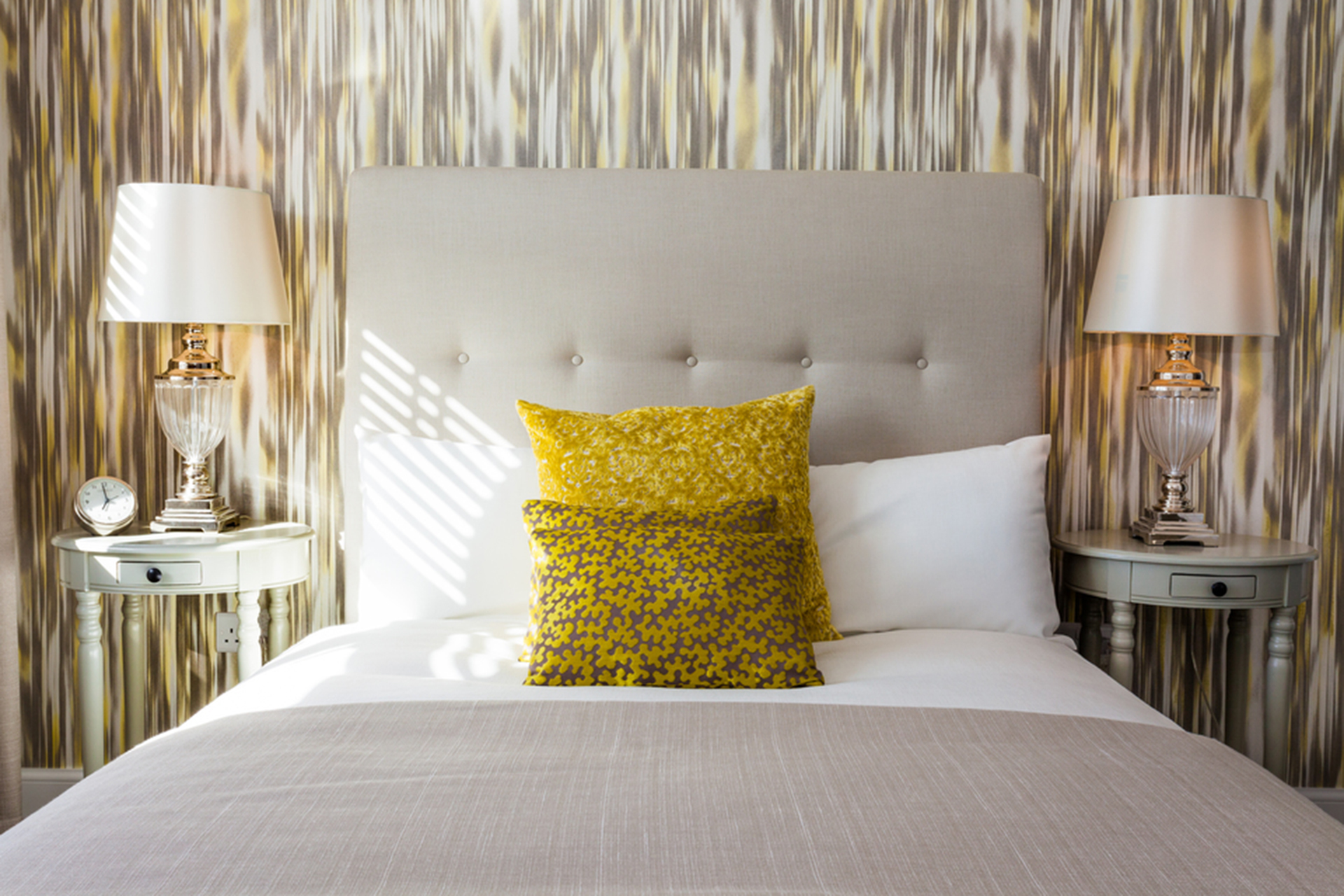 Bed decorated with yellow cushions