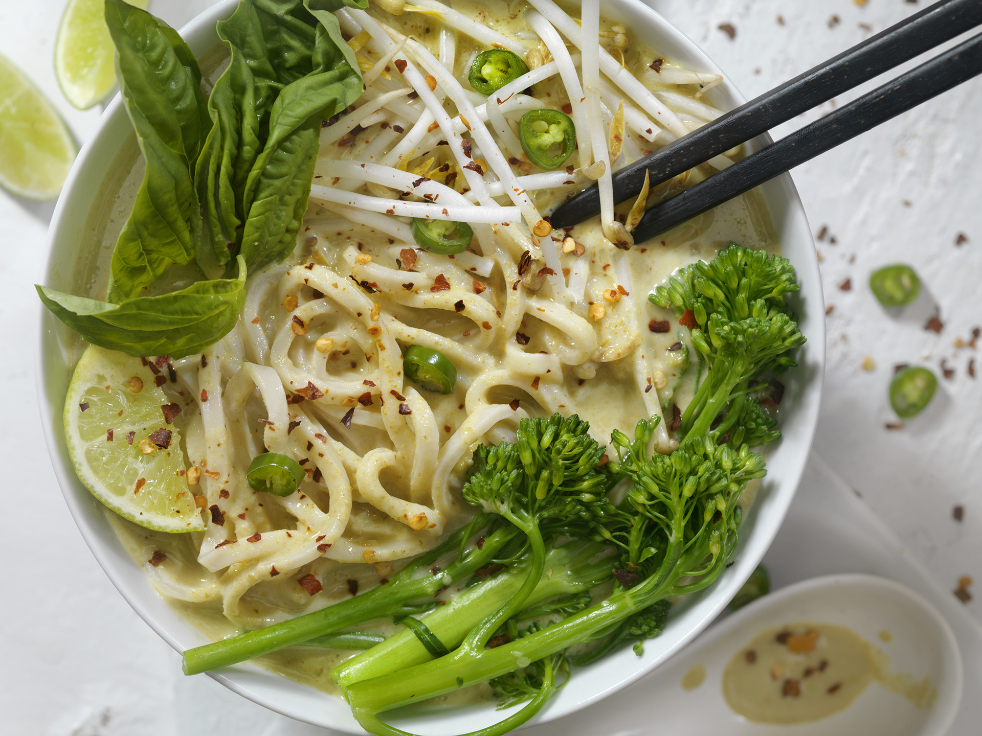 Thai Green Curry Noodle Soup with Broccoli, Bean Sprouts, Fresh Basil, Lime and Chili Flakes