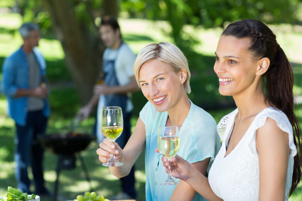 Ladies enjoying a glass of white wine at a barbecue Pic: Istockphoto