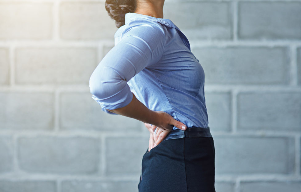 Cropped shot of a businesswoman suffering from back pain