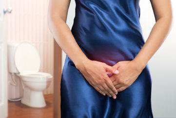 Woman with prostate problem in front of toilet bowl. Lady with hands holding her crotch, People wants to pee - urinary incontinence concept