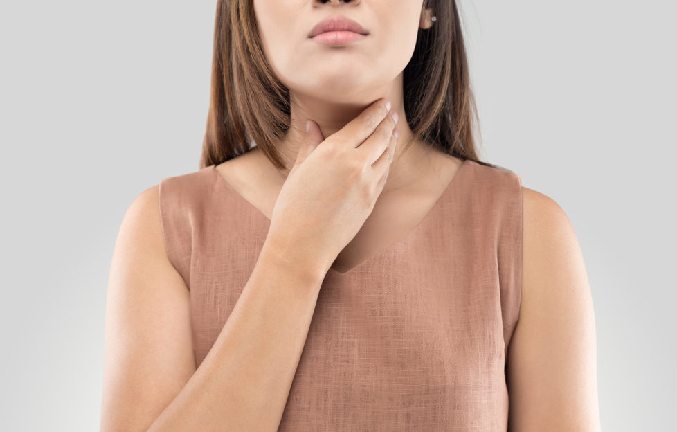 Sore throat woman on gray background