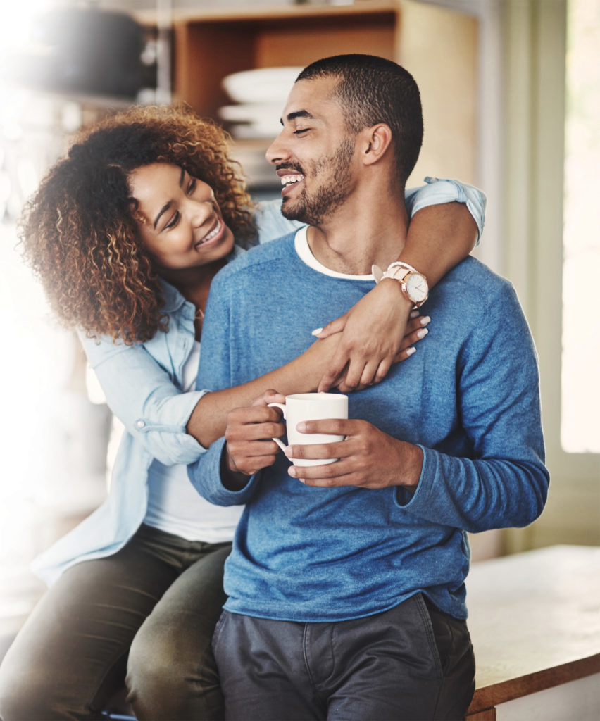 Couple with a cup of tea cuddling