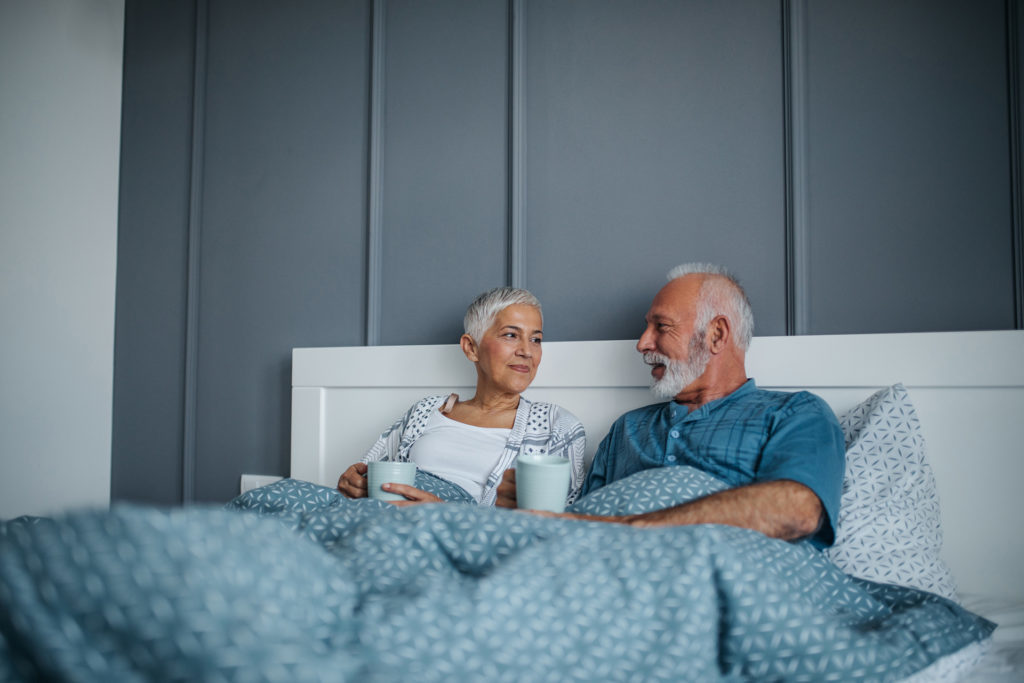 Shot of a mature couple having coffee in bed