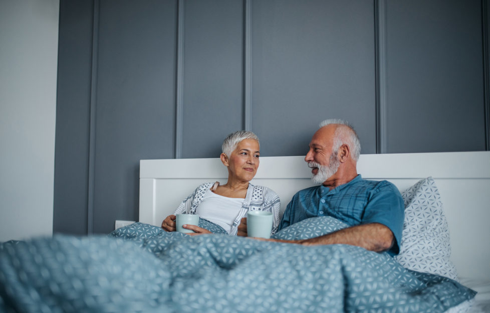 Shot of a mature couple having coffee in bed