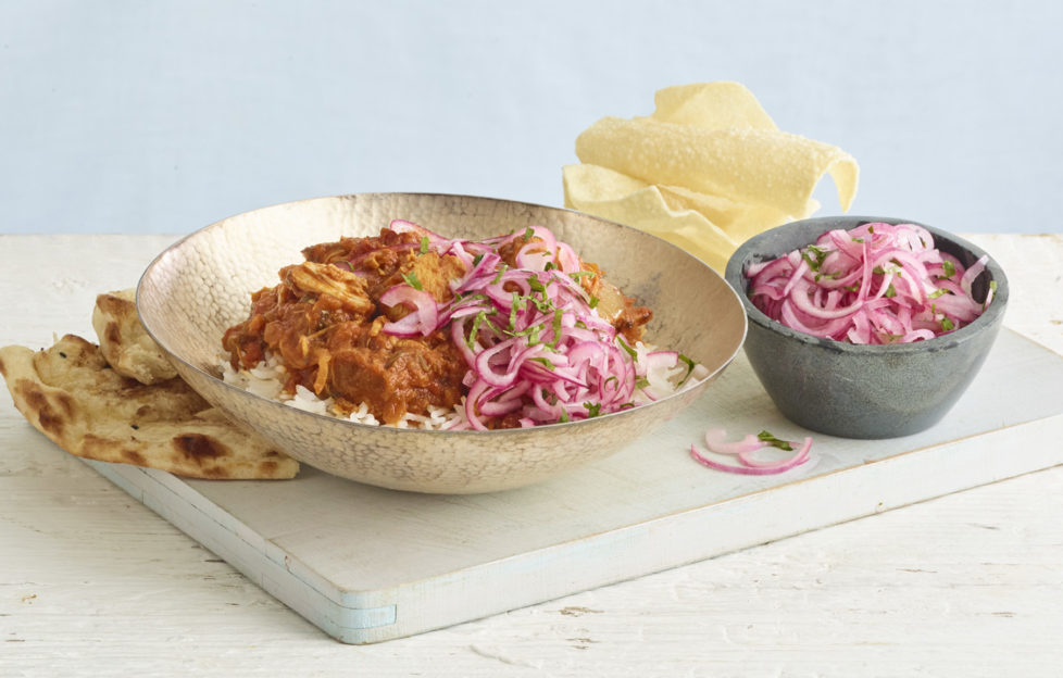 Curry in a bowl with rice and popadoms