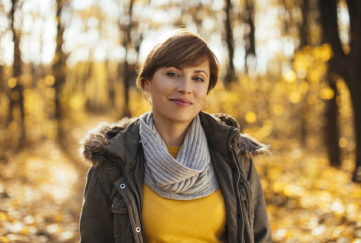 Young woman in the park on a sunny autumn day