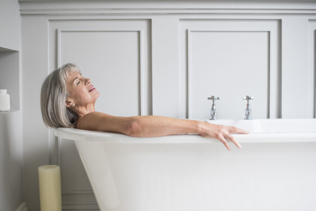 Senior woman relaxing in bath with eyes closed