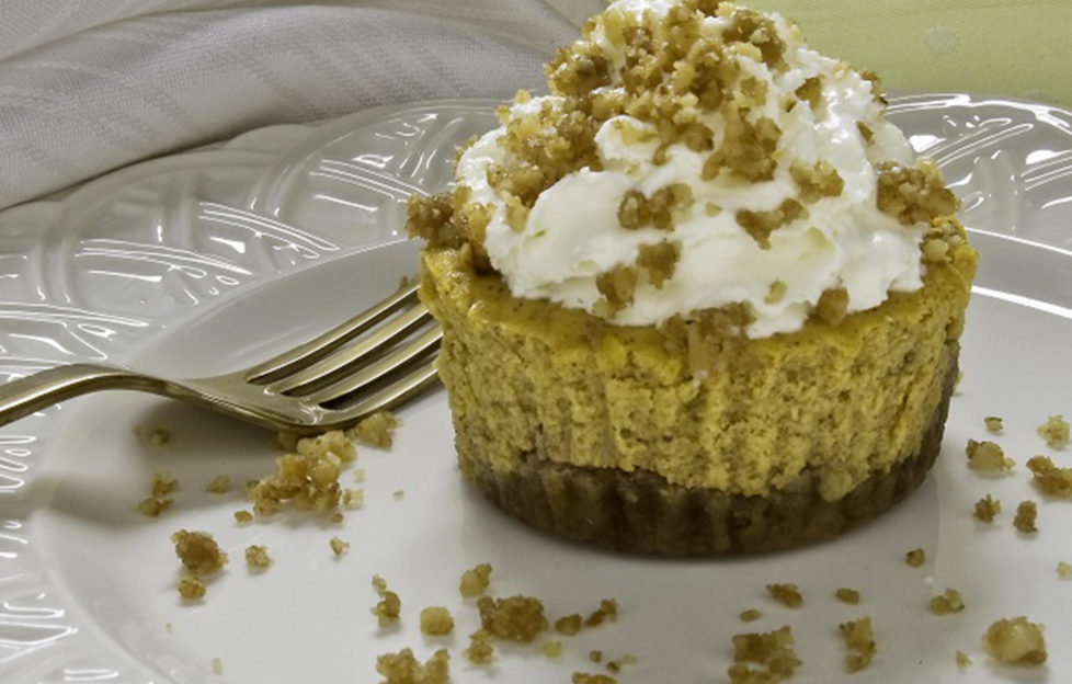 Pumpkin and California walnut cupcakes and fork on a plate surrounded by crumbs