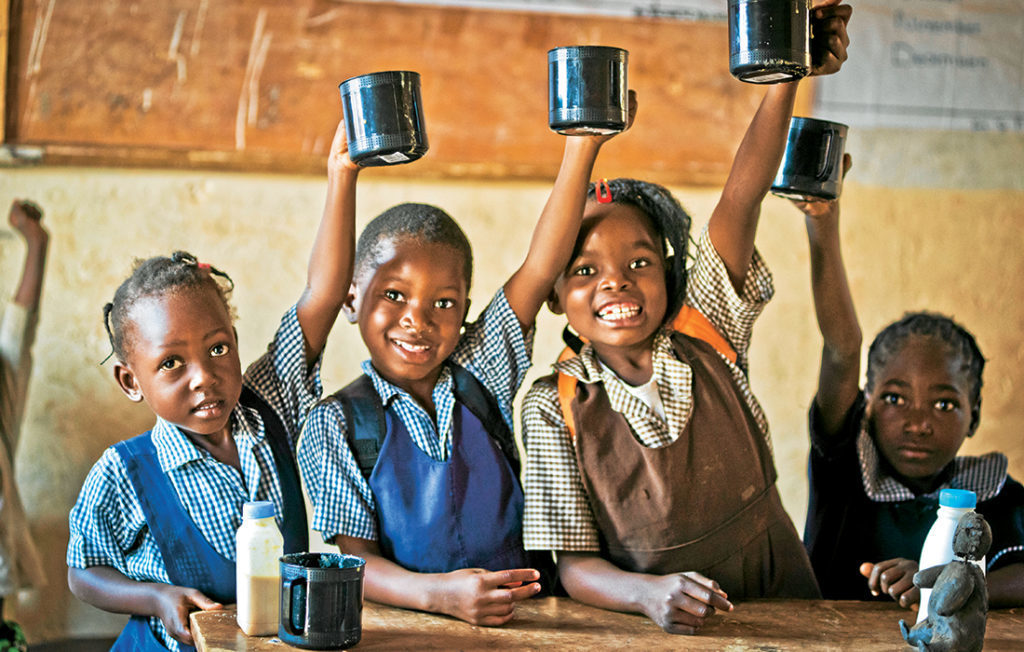 Schoolchildren with mugs of porridge Pic: Chris Watt