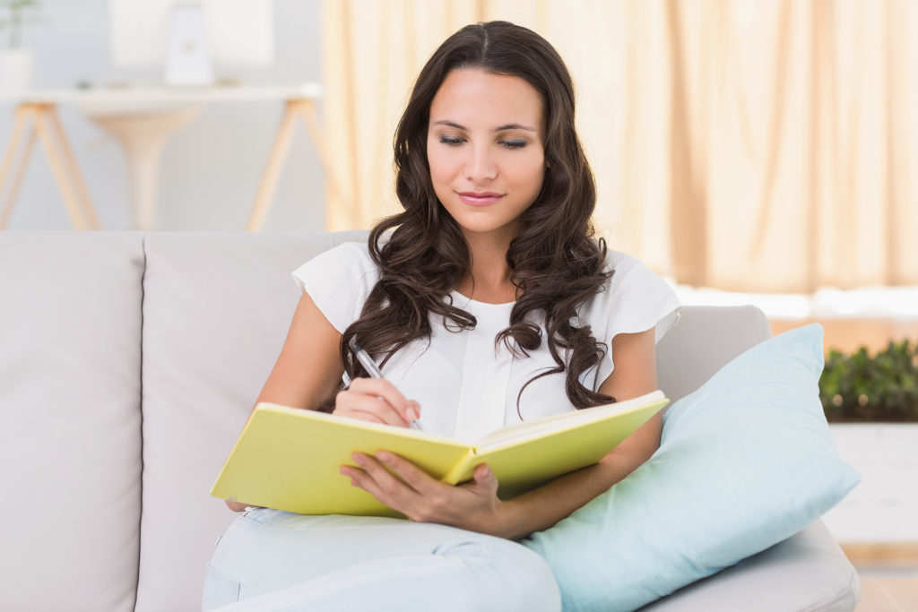 Woman writing in journal